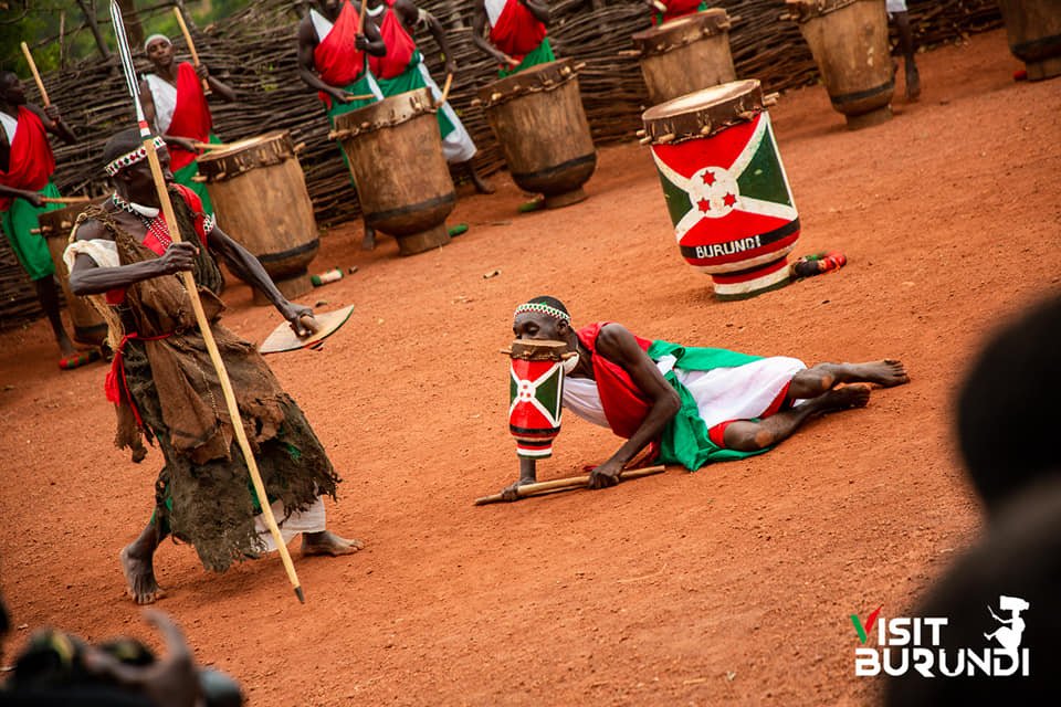 A royal drummer seated on the ground while performing at the Gishora Drum Sanctuary