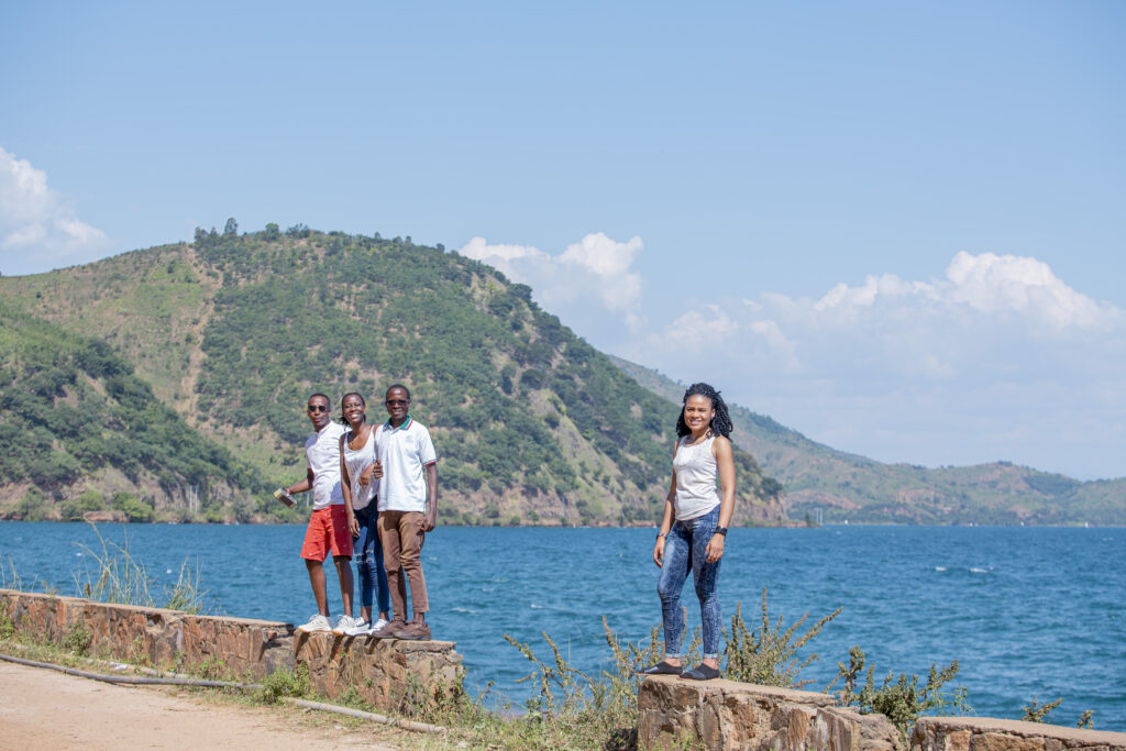 Locals posing for a photo in front of Lake Tanganyika